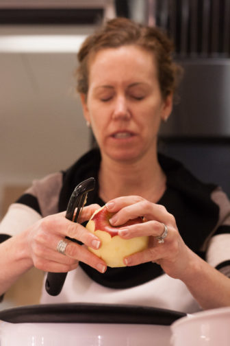 Student, Jane Fowler, learns technique to cut an apple with her eyes closed.