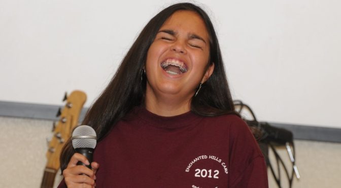 Maycie Vorreiter laughs while singing at the EHC talent show in 2012.