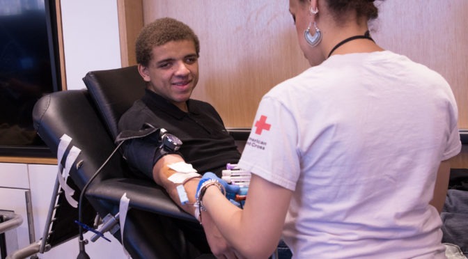 A LightHouse Youth program participant smiles while giving blood in February at LightHouse.