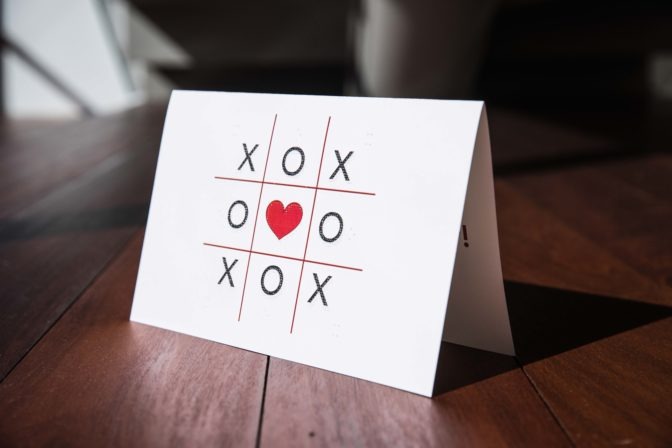 The inside of the card reads "Happy Valentine's Day!" in red large-print and braille.