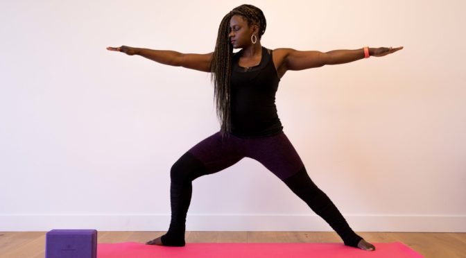 LightHouse Health and Wellness Program Coordinator Amber Sherrard shows off her Warrior 2 yoga pose.