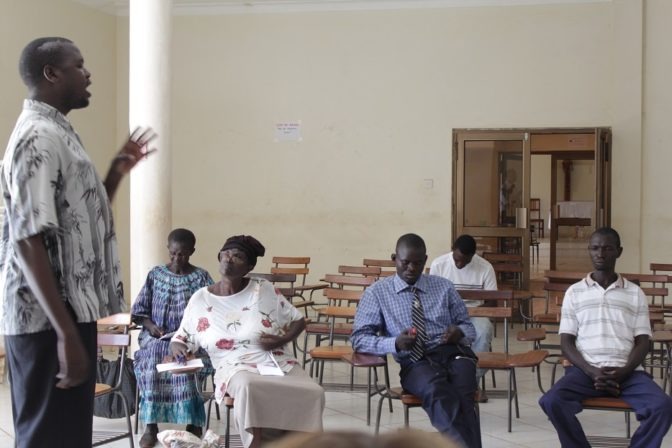 Ojok Simon addresses a classroom of Hive Uganda trainees.