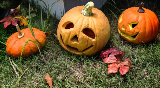 Two pumpkins and a jack-o-lantern