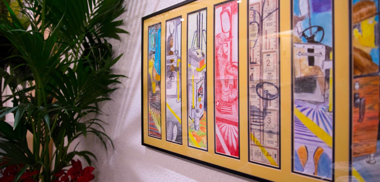 A panel of eight hand-colored drawings in a yellow template depict a series of city bus drivers and details of the front of a bus. In a variety of styles and colors, ranging from a dreamy purple coloring to a terse red rendition, the images depict, at once, a sense of urgency, agency and calm.