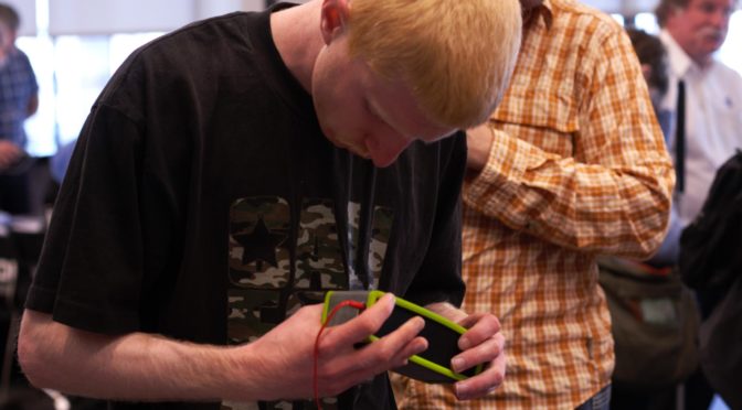 A student checks out a Bluetooth speaker at a LightHouse technology event.