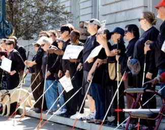 A group of LightHouse staff and community members promoting the Safe Streets project