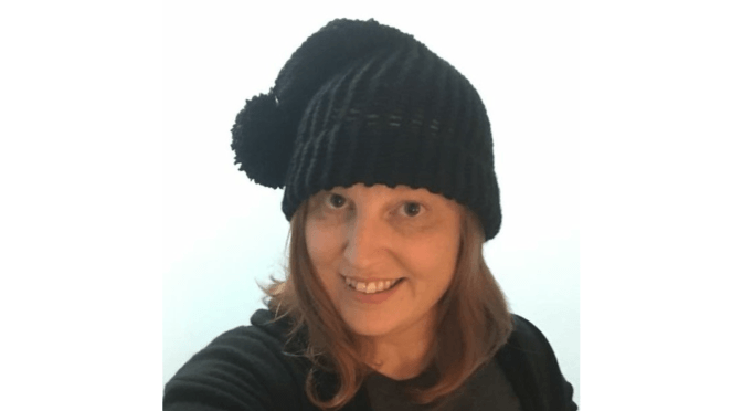 LightHouse Adult Program Coordinator Serena Olsen wears a knitted hat.