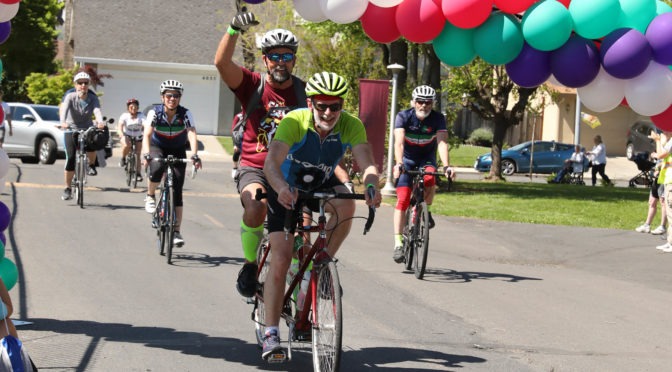 Tandem team David and Edwin ride their bike among four other bikers at Cycle for Sight in 2019