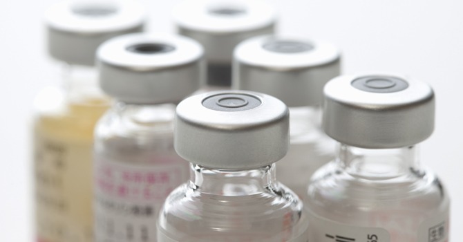 Close up image of a group of sealed glass bottles containing the vaccine