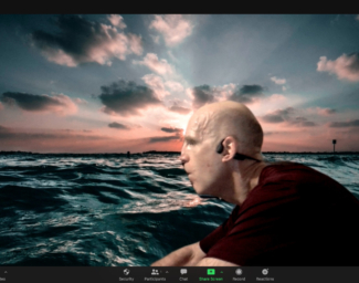 A Zoom image of Chris rowing with the English Channel as a virtual background
