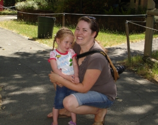 A women holds a young child outdoors