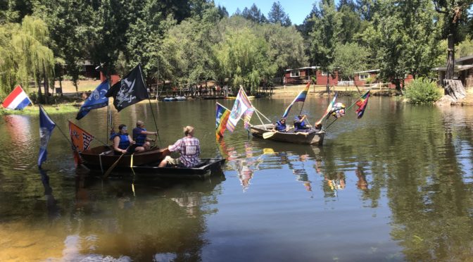 Teens row boats on Lake Lakoya at Enchanted Hills Camp