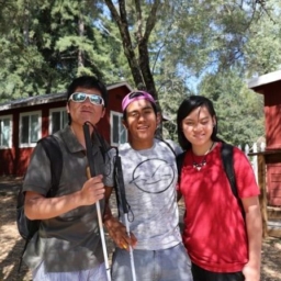 Teens pose in front of the cabins at EHC