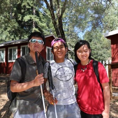 Teens pose in front of the cabins at EHC