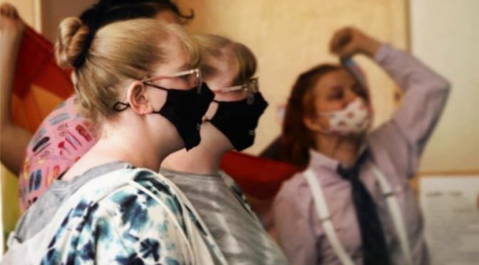 Teens wearing masks gather in the Kiva at EHC