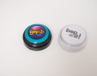 The Bop it button in color and black and white variations