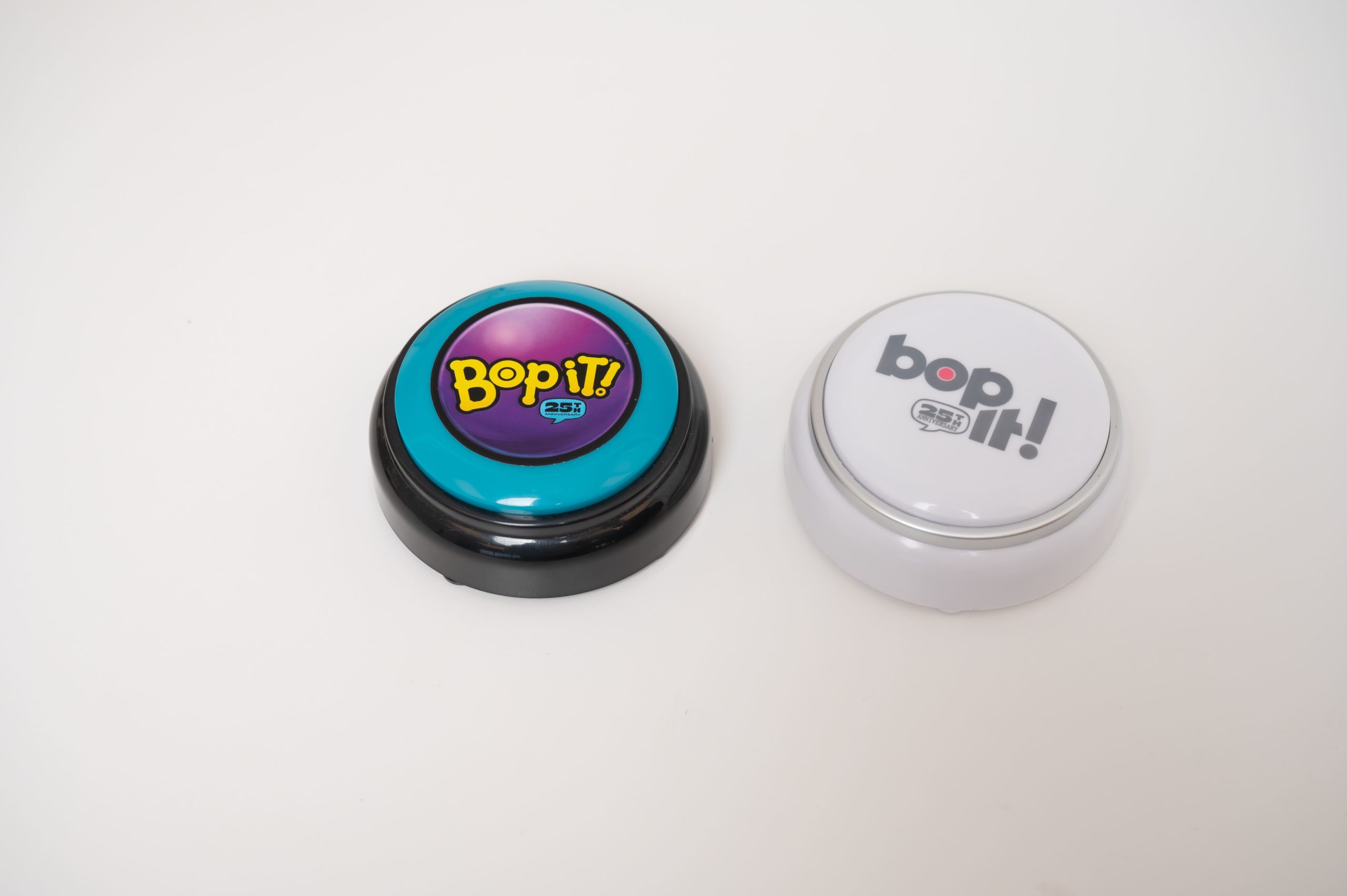 The Bop it button in color and black and white variations