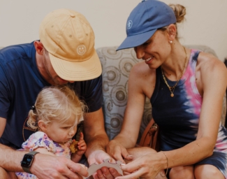 Hunter, Amanda and Little Learner sit on a couch