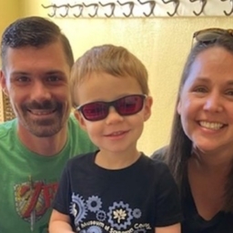 Dad, Little Learner and Amy kneel for a photo. Little Learner wears sunglasses