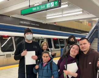LightHouse students John, Teressa, Joy, and Dreyson pose on the platform at 19th Street BART Station at the BART Safety Workshop
