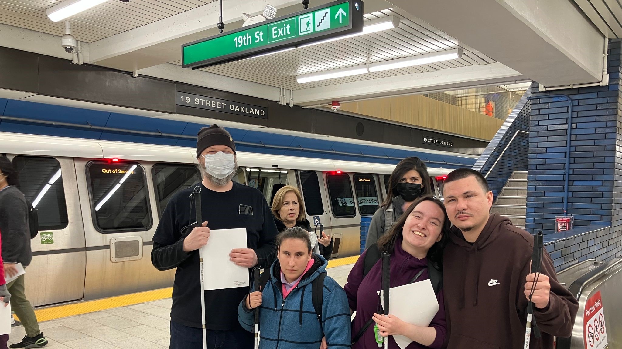 LightHouse students John, Teressa, Joy, and Dreyson pose on the platform at 19th Street BART Station at the BART Safety Workshop