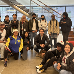 Latitude students and instructor pose with LightHouse community members and staff in front of the 10th floor staircase at LightHouse in 2023.