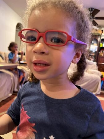 Little Learner Casey wearing glasses with pink frames
