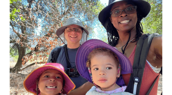 Little Learner Casey, Little Learner Mom Latasha and family smile while wearing sunhats in various colors
