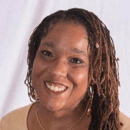 Kari Kelly, a black woman with thin braids in her hair