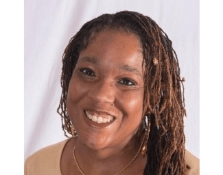 Kari Kelly, a black woman with thin braids in her hair