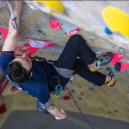Image looking down on Andrew climbing up a paraclimbing rock wall