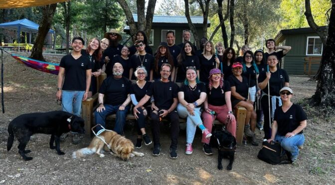 The EHC Summer 2023 Staff pose together at a picnic table at Enchanted Hills Camp in Napa