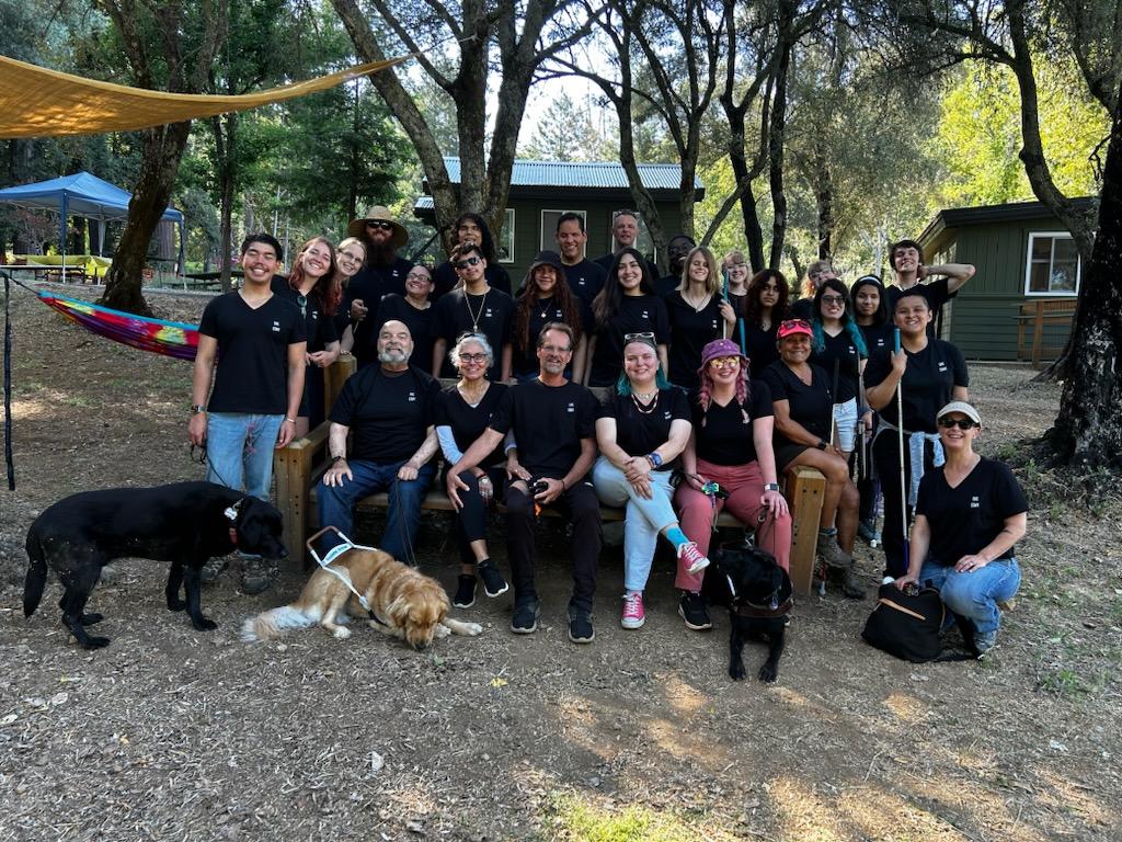 The EHC Summer 2023 Staff pose together at a picnic table at Enchanted Hills Camp in Napa