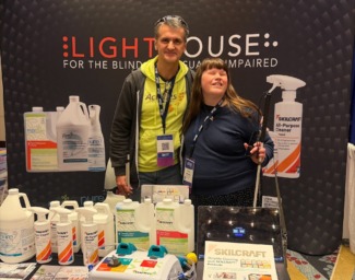 Corvin and Jenn pose together at the LightHouse Eco exhibit table at the National Industries for the Blind Expo in Washington DC