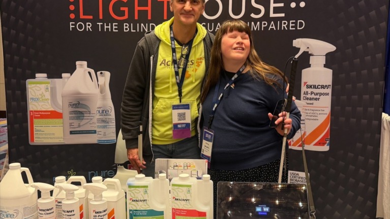 Corvin and Jenn pose together at the LightHouse Eco exhibit table at the National Industries for the Blind Expo in Washington DC