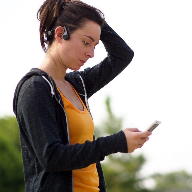 Woman wearing Aftershokz Bluez 2 Bluetooth Wireless Bone Conduction Headphones