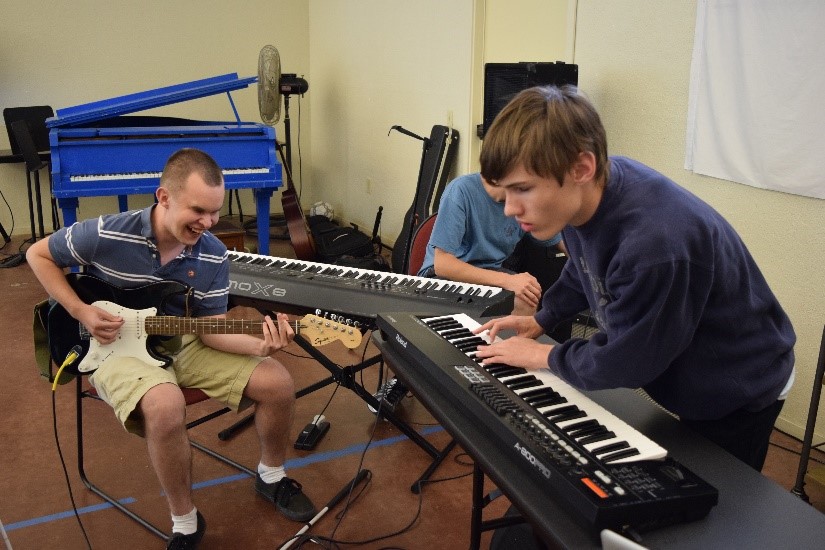 Music Academy students Travis Nichols (left) plays electric guitar and Ben Blatchford on keyboards.