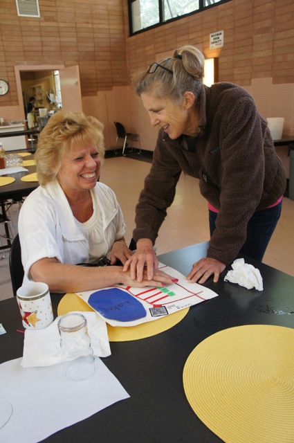 Orientation & Mobility instructor Terry Wedler works with student Oma Cardenas using a make-shift tactile map (photo credit: Lorraine Miller-Wolf)