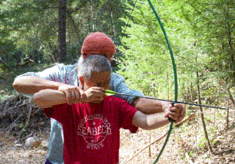 Instructor Ben Oude Kamphuis shows camper Tony So how to hold a bow and arrow during Archery Class at last year’s Deaf-Blind camp session