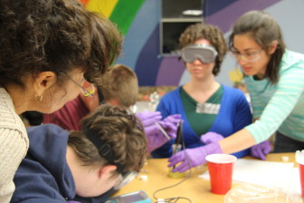 Students watch a chemistry experiment during Chemistry Camp.