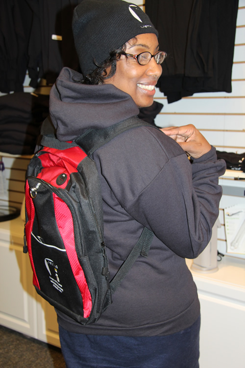 LightHouse receptionist Christina Daniels models one of our beautiful backpacks which can be yours while they’re available during our Holiday Swag Sale