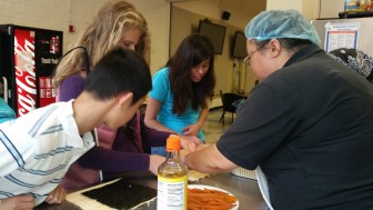 LightHouse staffer Molly Irish teaches sushi making to Cooking 101 students