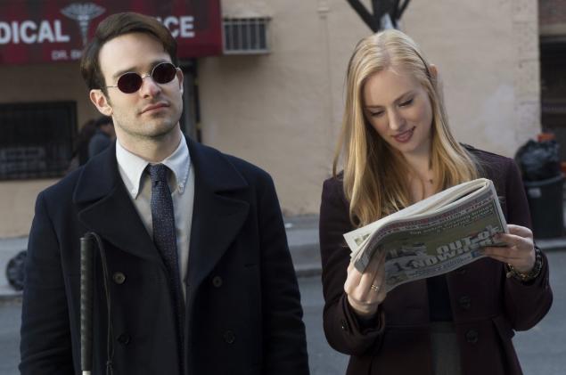 photo: a still from Netflix's Daredevil in which a woman reads Daredevil the newspaper